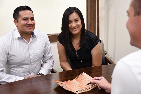 A young couple talks to a Waldo State Bank employee about personal banking